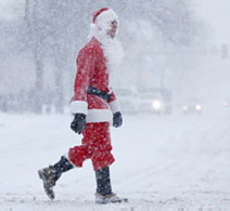 Santa Claus crosses a street on his way to a bar during a snow storm.. THE ASSOCIATED PRESS/Matt Rourke.