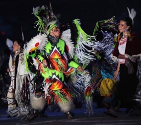 Performers representing diverse aboriginal peoples of Canada dance during the opening ceremony, welcoming guests to home and native land. Photograph by: ADRIAN DENNIS, AFP/Getty Images.