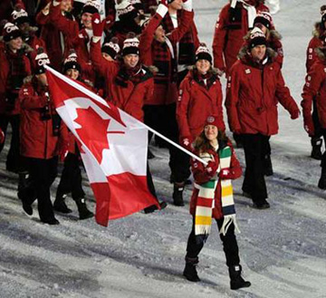 Athletes from host nation Canada march into BC Place at opening ceremony, with Clara Hughes carrying flag and wearing ancient Hudson ‘s Bay Company scarf. Photograph by Larry Wong / Canwest News Service.