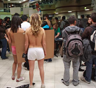 Accounting student Chelsea Bokor, right, and Marketing student Ashley Dinh wear barely the clothes on their backs as they listen to University of Calgary Provost Alan Harrison defend the recent tuition increase announcements at the MacEwan Student Centre February 2. Photograph by: Ted Rhodes, Calgary Herald.