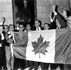 Members of Parliament celebrate inauguration of independent Canadian flag, at last, February 15, 1965.